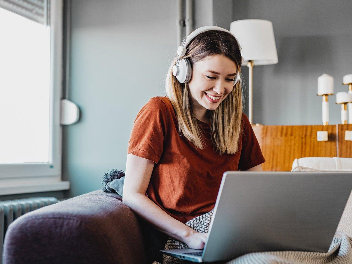Woman on laptop with headphones on