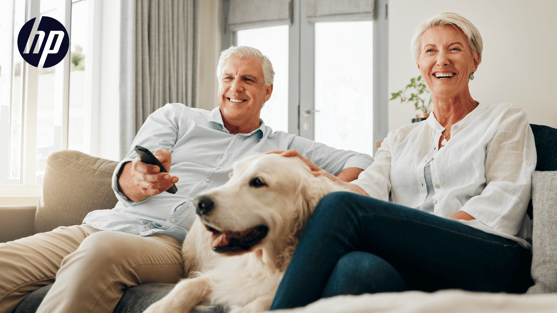 Image of a couple with a dog, watching TV