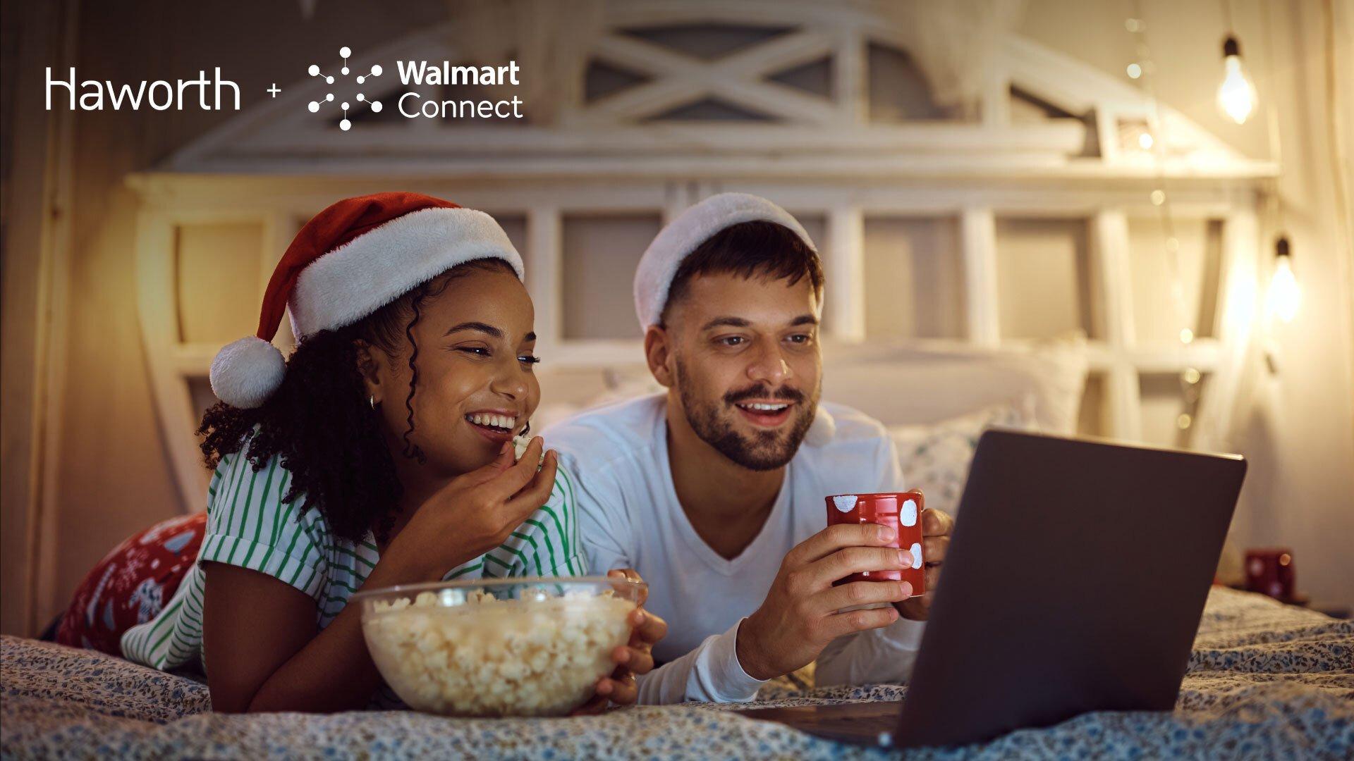 Image shows a couple eating popcorn and drinking from a mug while watching tv on a laptop. Haworth and Walmart Connect logos sit at the top left side of the image.