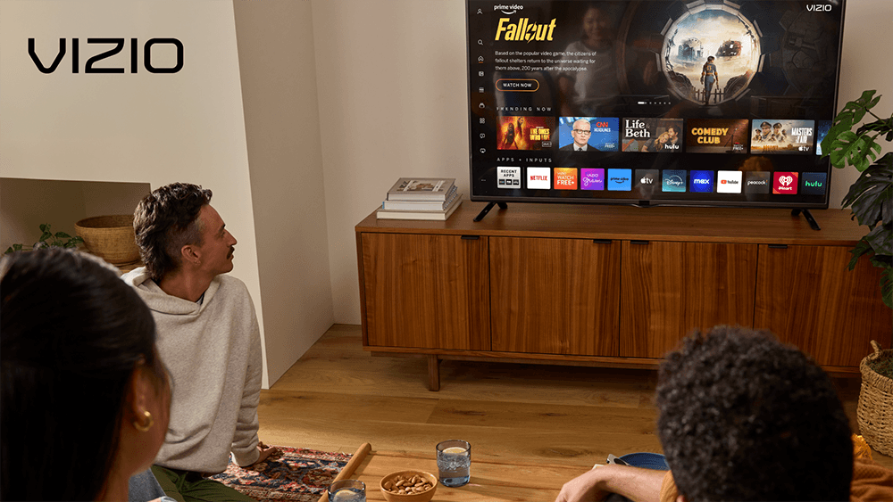 Image of a group of people watching a TV, with VIZIO logo in the top left corner