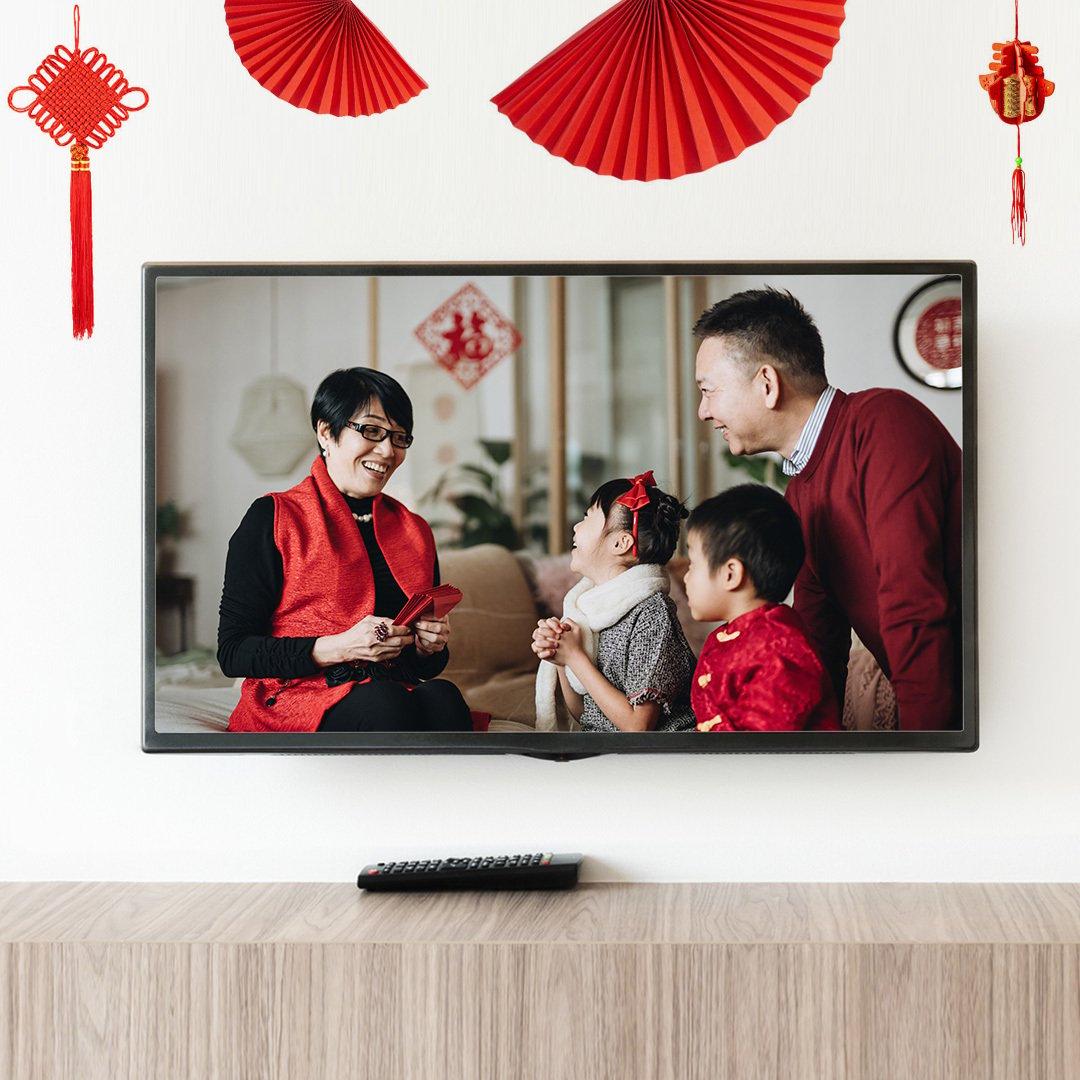 Image of a family inside of a TV, celebrating Lunar New Year